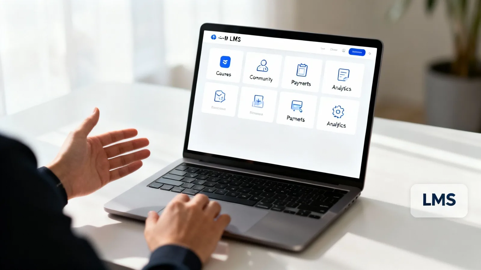 A person interacts with a laptop displaying an LMS dashboard featuring courses, community, payments, and analytics.